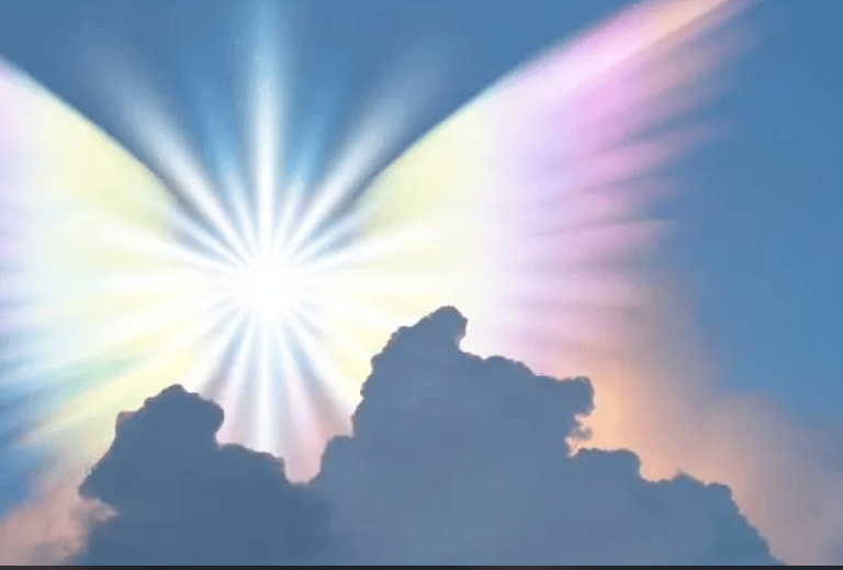 A bright spiritual light with rainbow angel wings glowing behind dark clouds in a blue sky 
