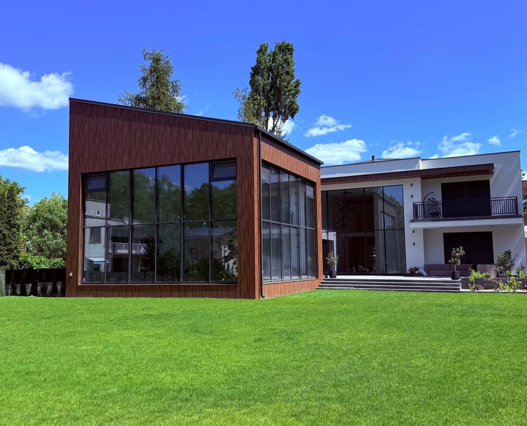 a house with a large lawn and a fenced in area