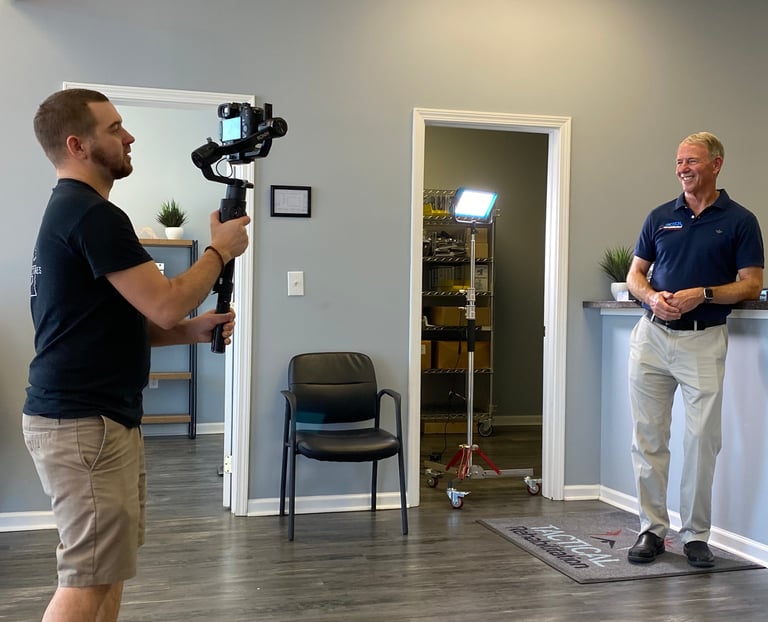 Jacksonville NC video producer Chris Lee filming on-location with professional gear.