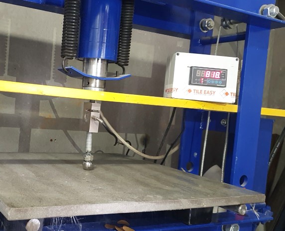 Tile being tested for point load strength