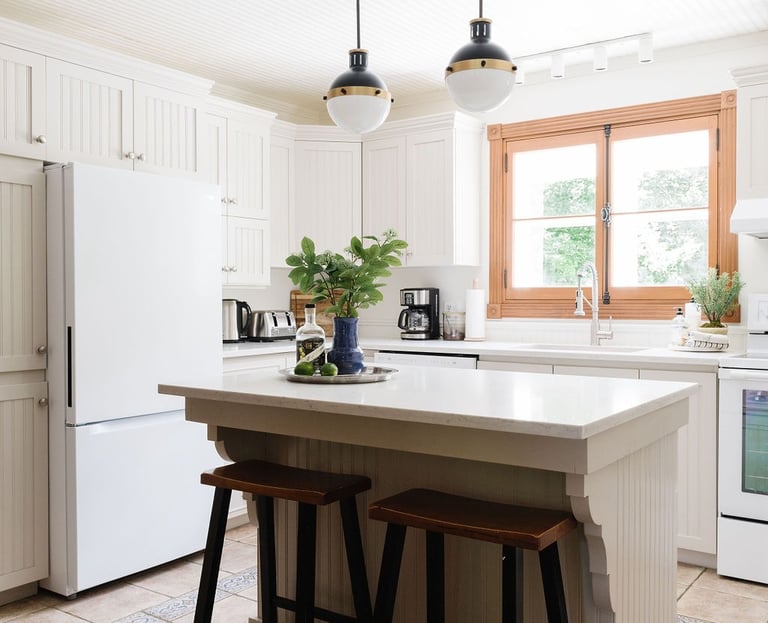 a kitchen with a large island and a white refrigerator