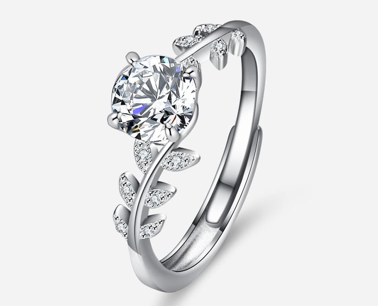 a diamond ring with a leaf design on the side