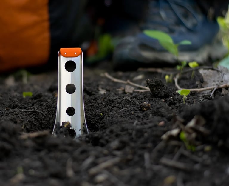 boglerco trowel stuck in ground with backpack and boots in background