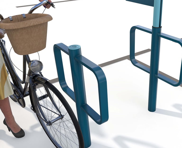 Teal metal bicycle parking rack with a vintage cruiser bike and wicker basket in an urban setting.