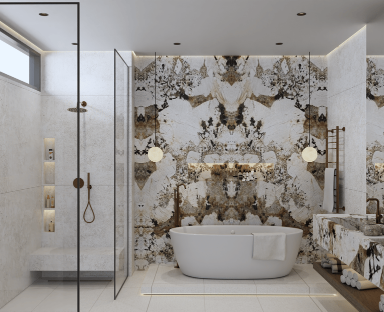 Luxurious bathroom with a white freestanding bathtub against a Patagonia Marble wall.