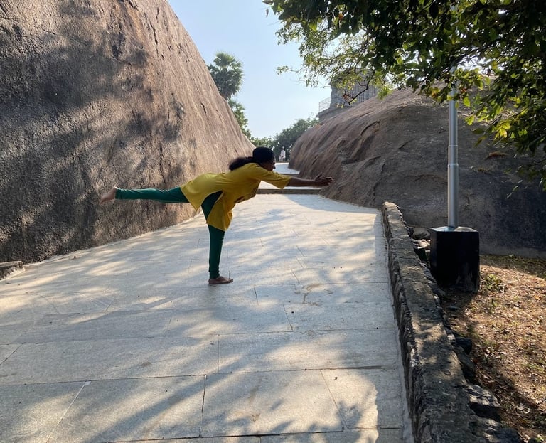 a woman in a yellow shirt is doing yoga