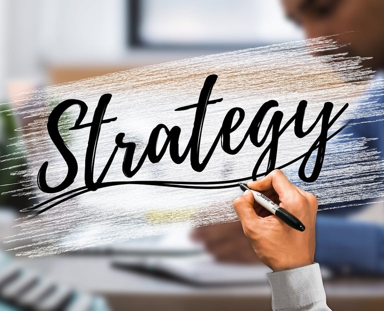 Hand writing the word Strategy on a digital glass board in a corporate business office setting.