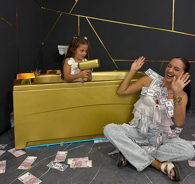 Creative photography in a golden bathtub with money props at Split's interactive museum.