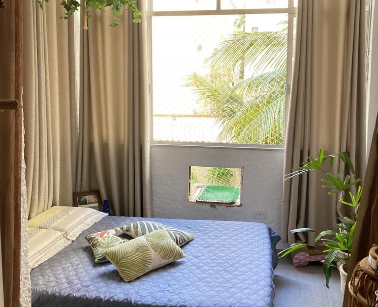 a bed room with a bed and a window