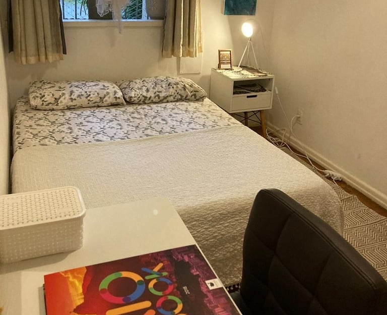 a bed room with a bed and a desk