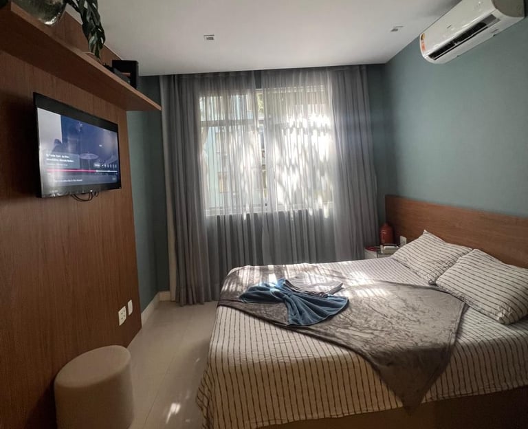 a bedroom with a bed and a television