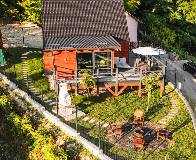 a wooden house with yard and fire pit