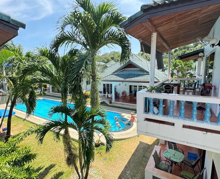Tropical garden and swimming pool view from Yanui Apartments terrace