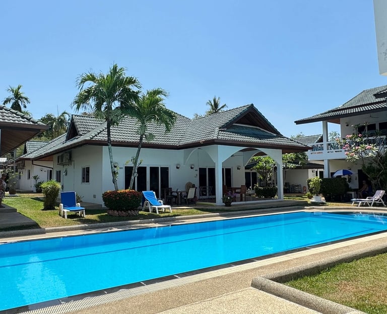 Yanui Apartments Phuket exterior with large private swimming pool and garden