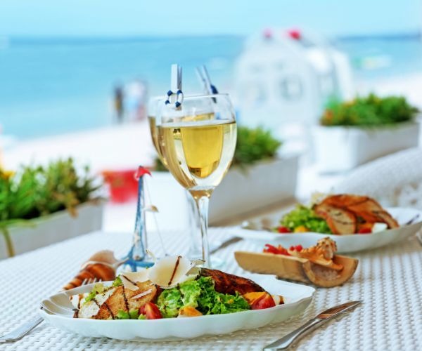 a table with a glass of wine and food