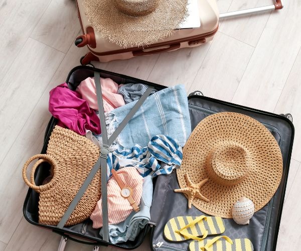 a suitcase with a hat on top of it