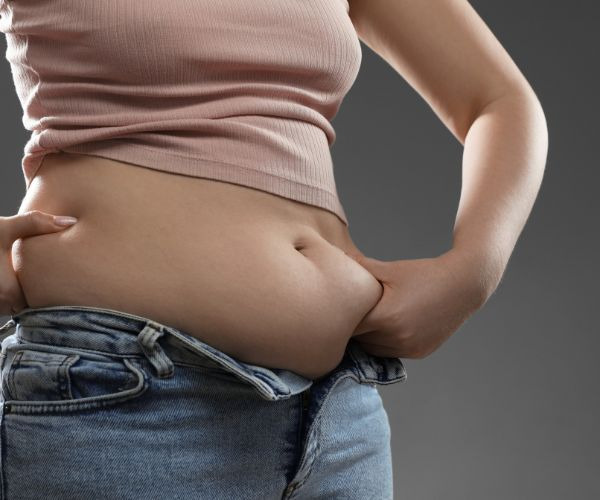 woman pinching her belly