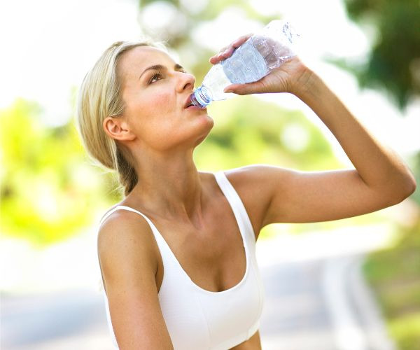 WOMAN drinking a bottle of water
