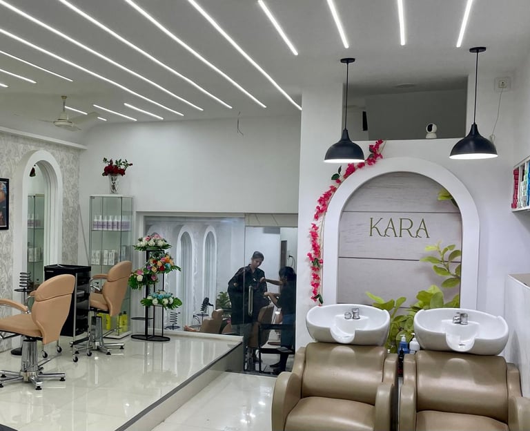 Stylish Kara Salon interior with floral branding and elegant hair stations.