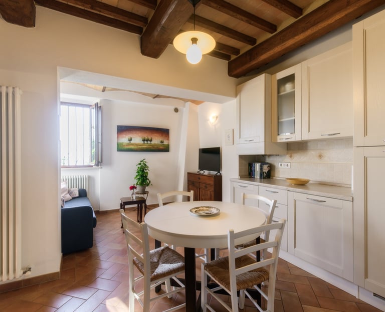 a kitchen with a table and chairs in the middle of the room