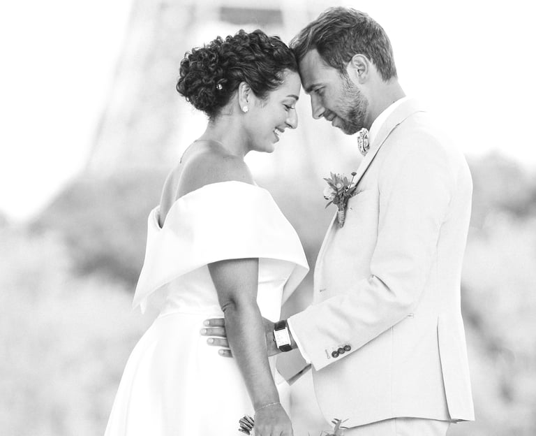 Black and white portrait of a bride and groom in Paris with the Eiffel Tower in the background.