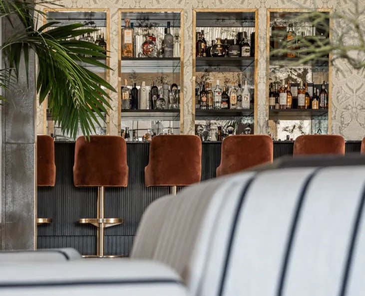 Cocktail bar at Villa La Gratitud with custom cabinetry and velvet seating