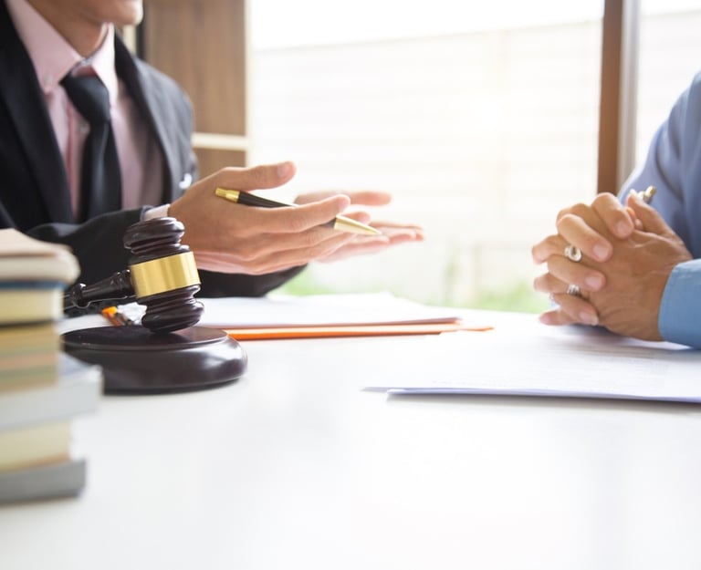 lawyer speaking to client at table