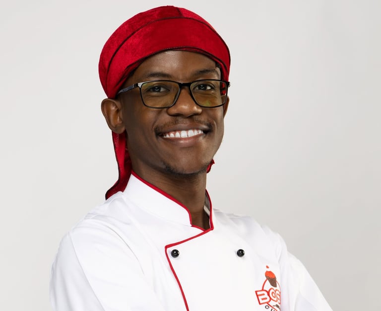 a man in a chef's uniform and a red hat