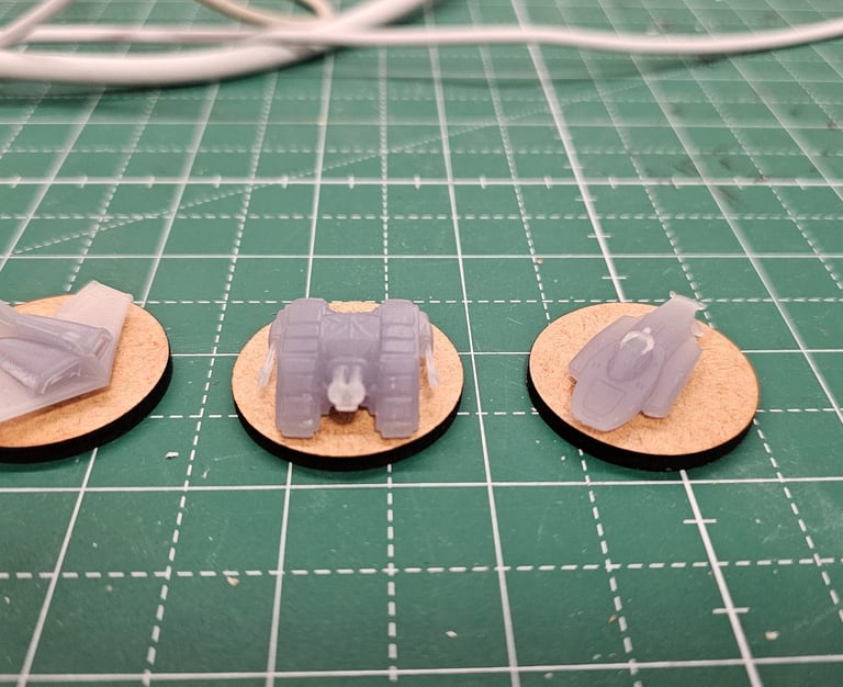 a pair of small plastic toy cars on a table