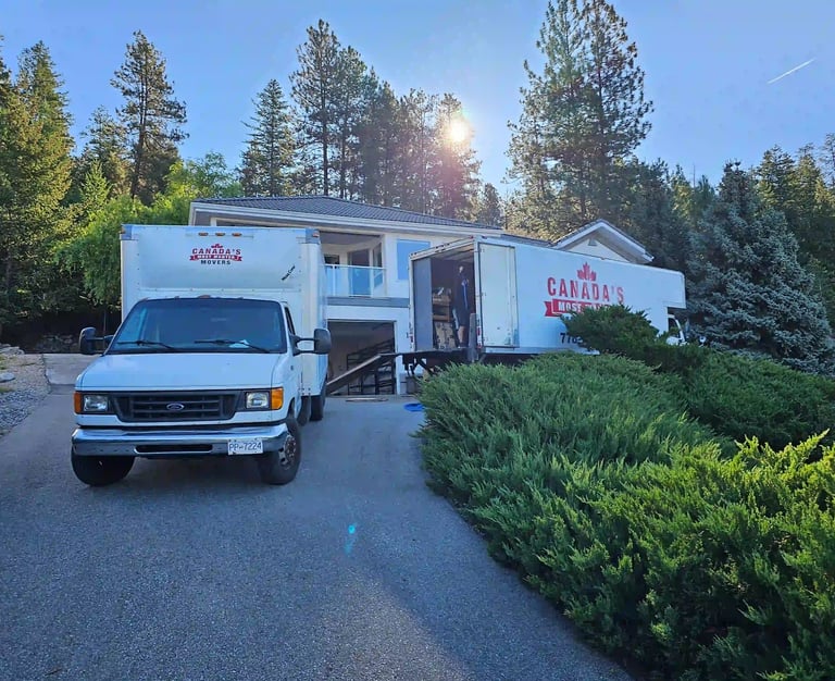 Canada’s Most Wanted Movers trucks loading at a hillside residential property in the Lower Mainland.