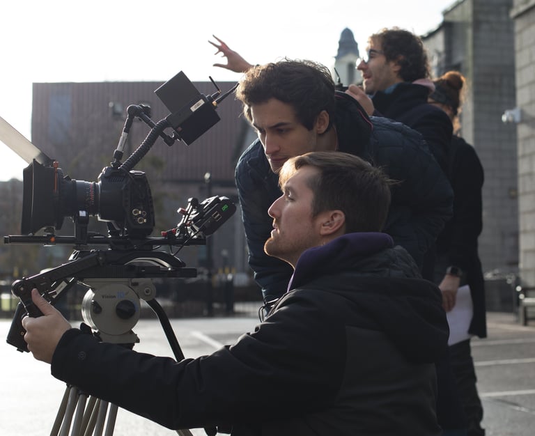 Film production services: a man holding a camera and a second camera