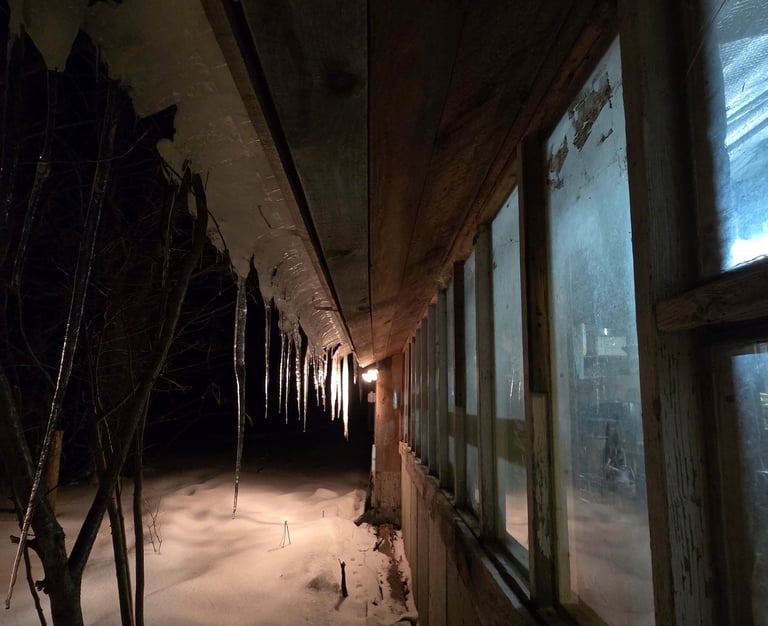 ice and snow outside a dark window