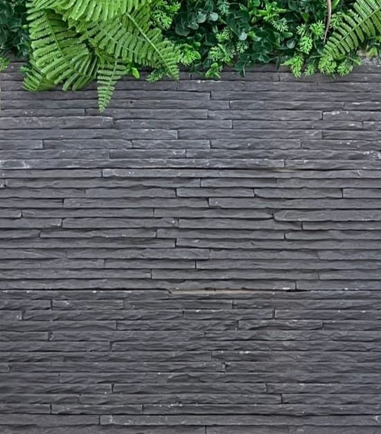a man in a suit and tie standing on a wooden deck