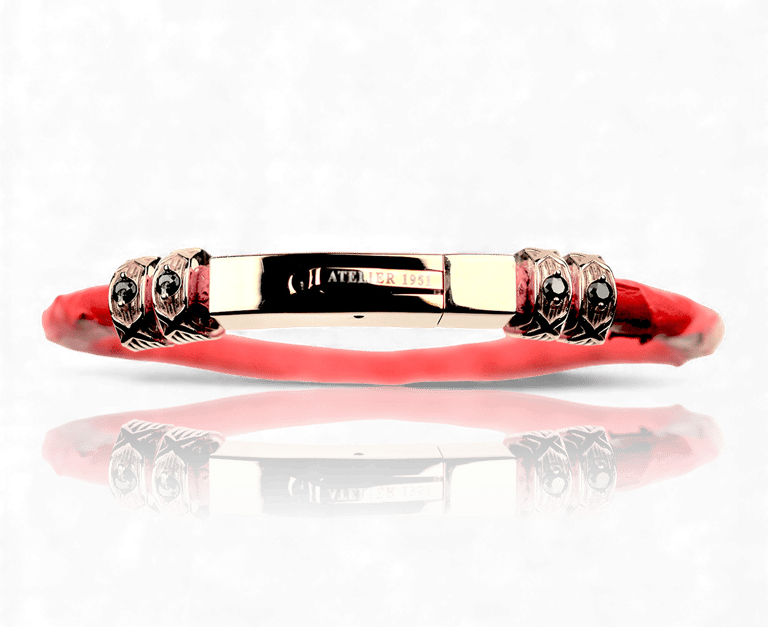 Luxury red band bracelet with gold hardware and black gemstone accents from Atelier 1951.