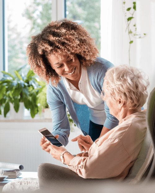 elderly woman with age related macular degeneration getting cell phone training for visual impairment