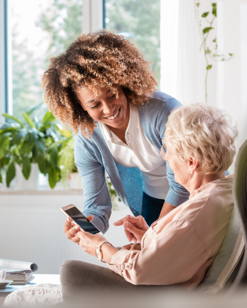 elderly woman with age related macular degeneration getting cell phone training for visual impairment