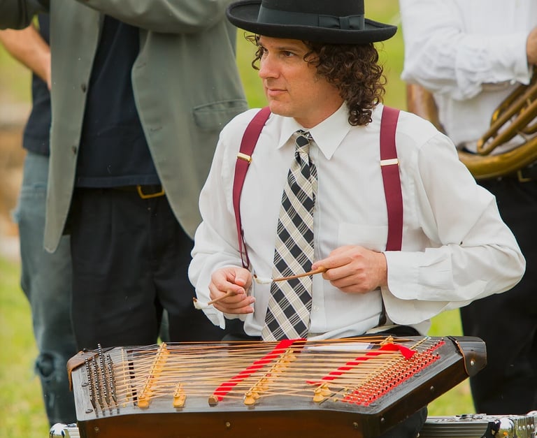 David Ansel playing tsimbl during a Mazel Tov Kocktail Hour show