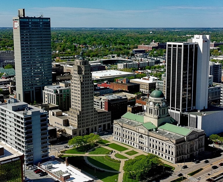Aerial view of downtown Fort Wayne skyline featuring the Allen County Courthouse and historic skyscrapers.