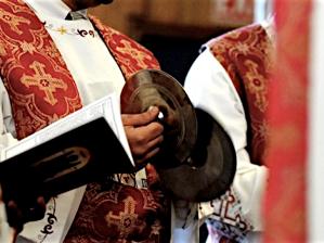 a priest holding a bible