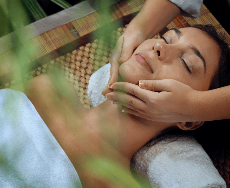 a woman getting a facial massage at a spa