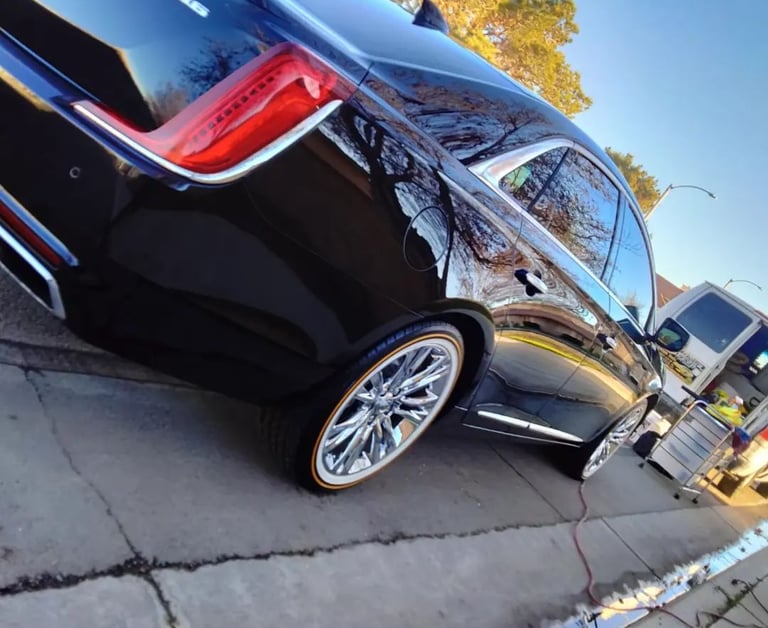 a detailed car parked behind detailing van