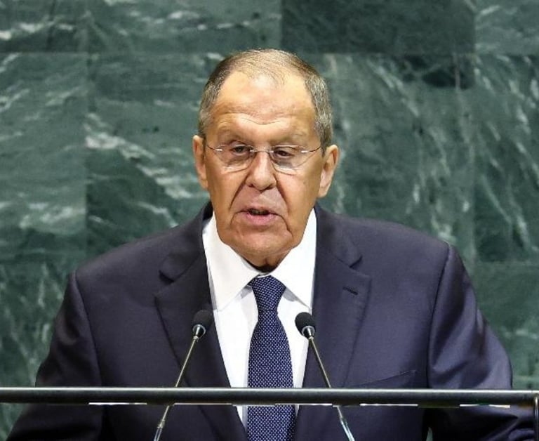 a man in a suit and tie standing at a podium