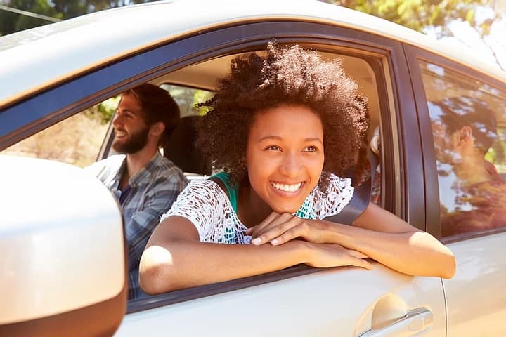 Happy Learner leaning out of car window