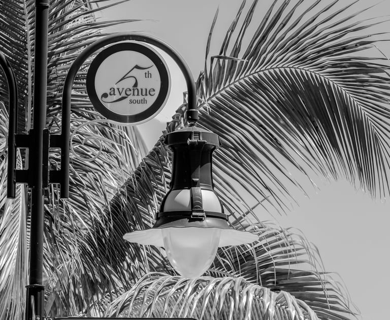 a light pole and street sign saying 5th eve s, in downtown naples florida