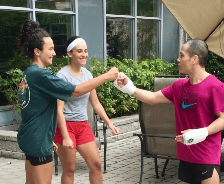 A woman is giving a fist bump to MARK RECAIDO after training Jeet Kune Do North York!