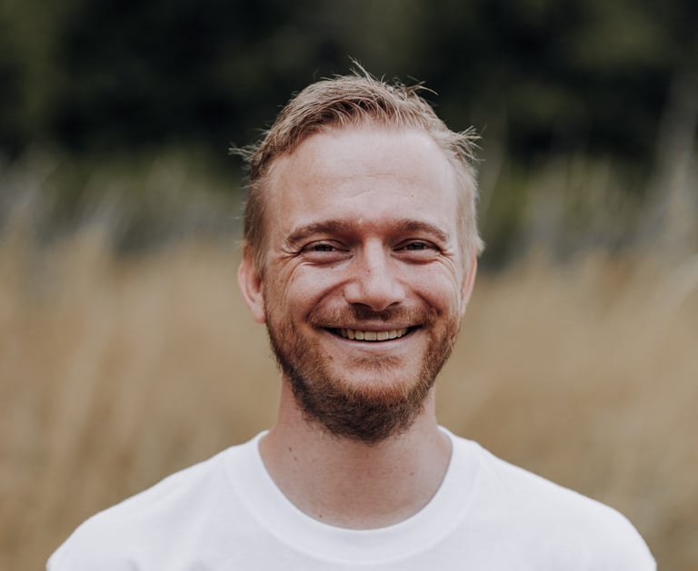 a man with a beard and a beard, smiling