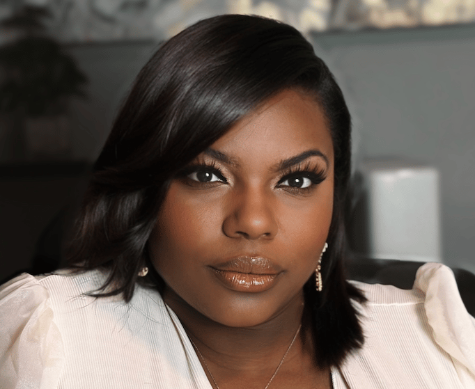 a black woman in a white shirt