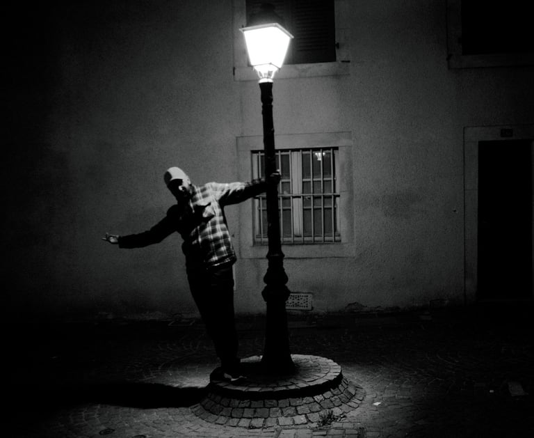 a man standing on a street light pole
