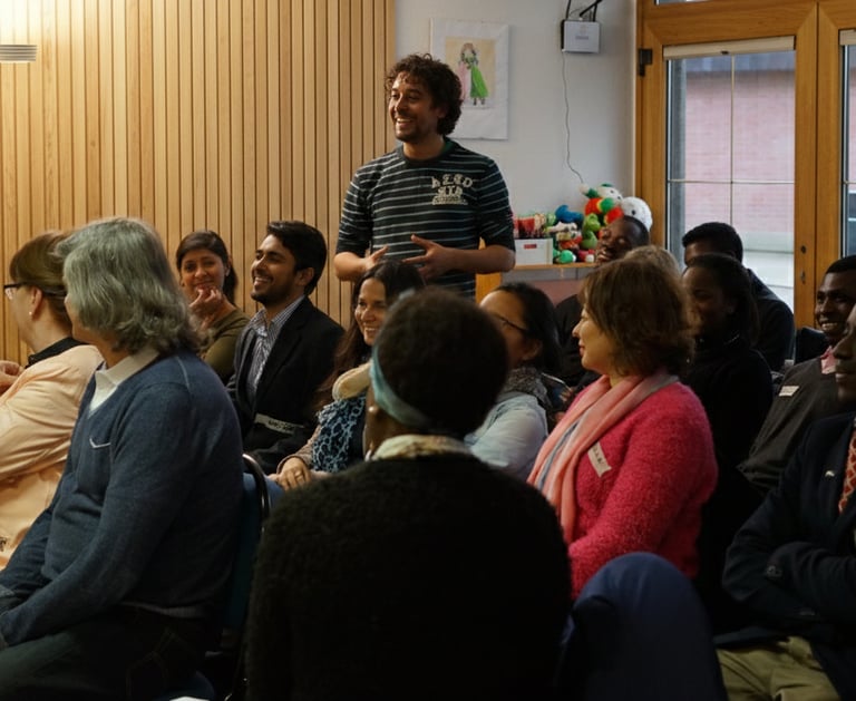 A diverse group of professional adults attending an engaging workshop and networking event.