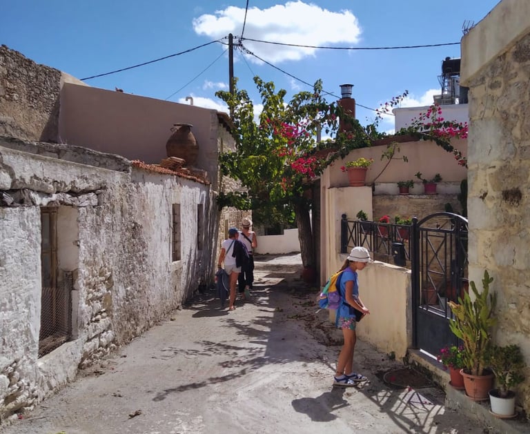 People strolling through the charming village of Alagni, surrounded by traditional stone houses.